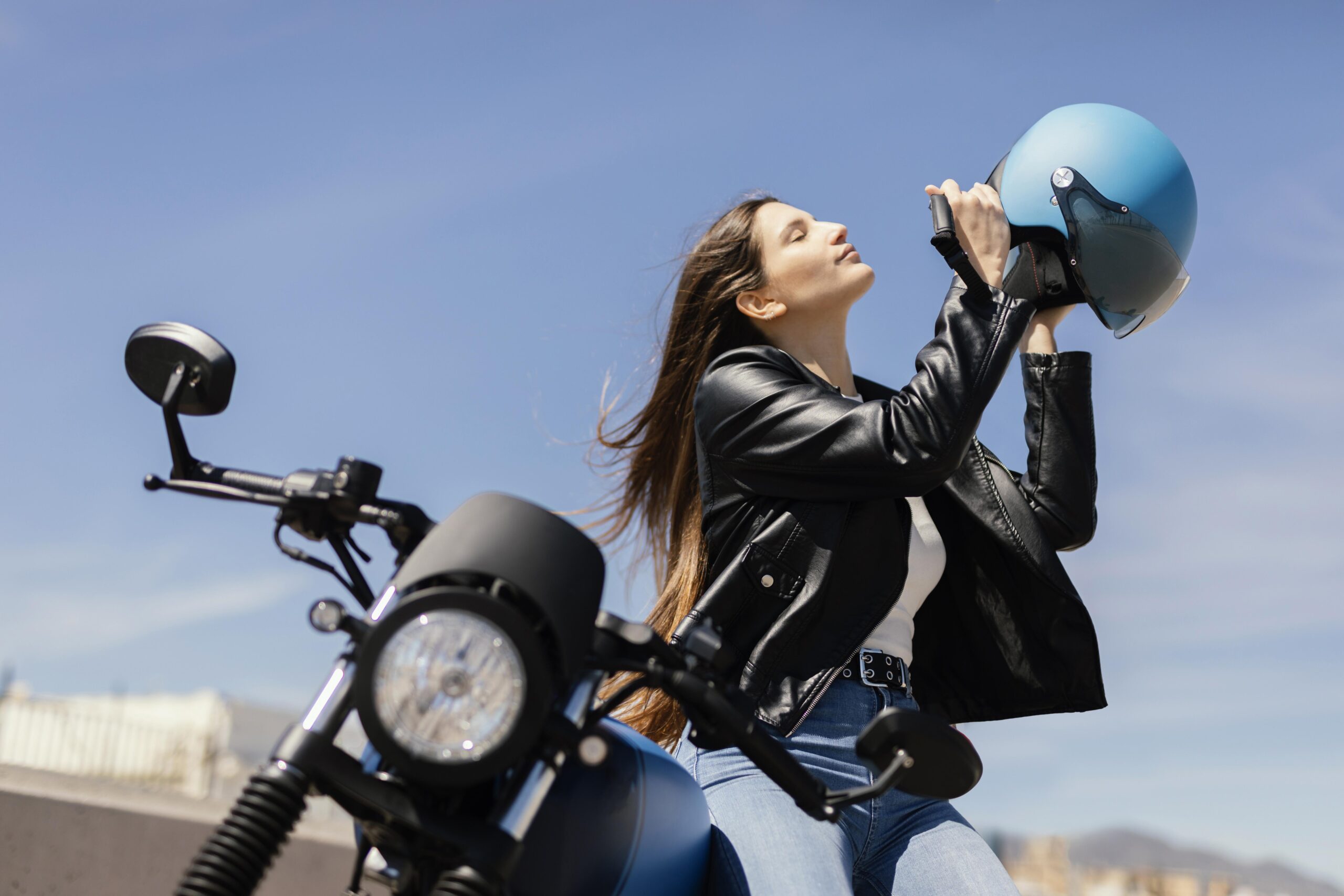 young woman preparing ride motorcycle city